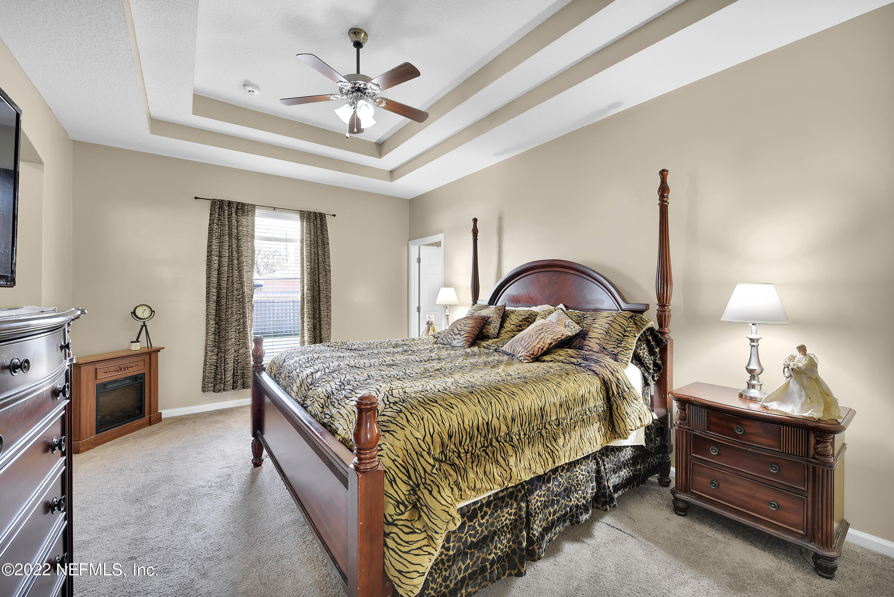 11941 Crooked River Road Jacksonville, FL 32219 - Photo 12 of 28 a bedroom with a bed and a chandelier