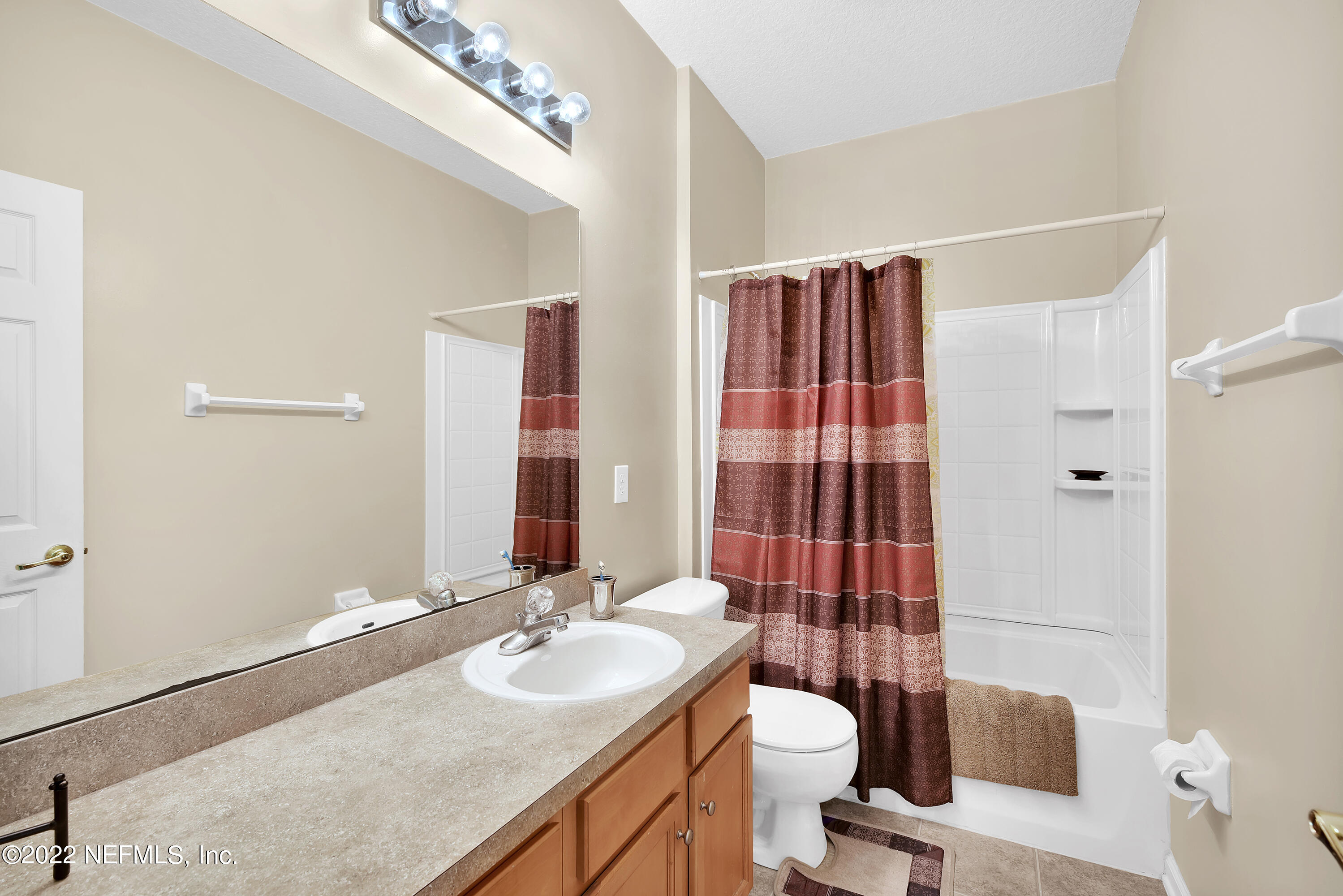 11941 Crooked River Road Jacksonville, FL 32219 - Photo 14 of 28 a bathroom with a sink and a mirror