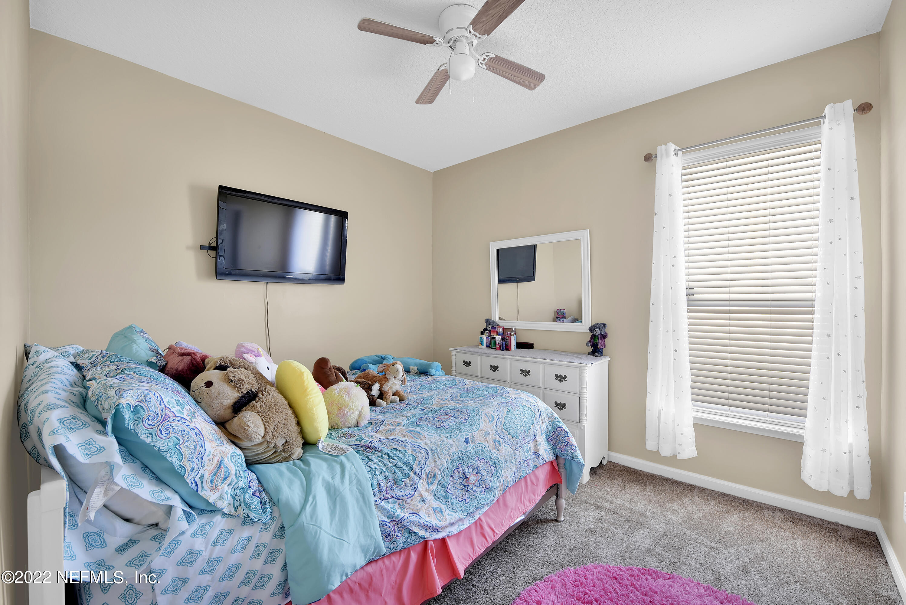 11941 Crooked River Road Jacksonville, FL 32219 - Photo 15 of 28 a bedroom with a bed and flat screen tv
