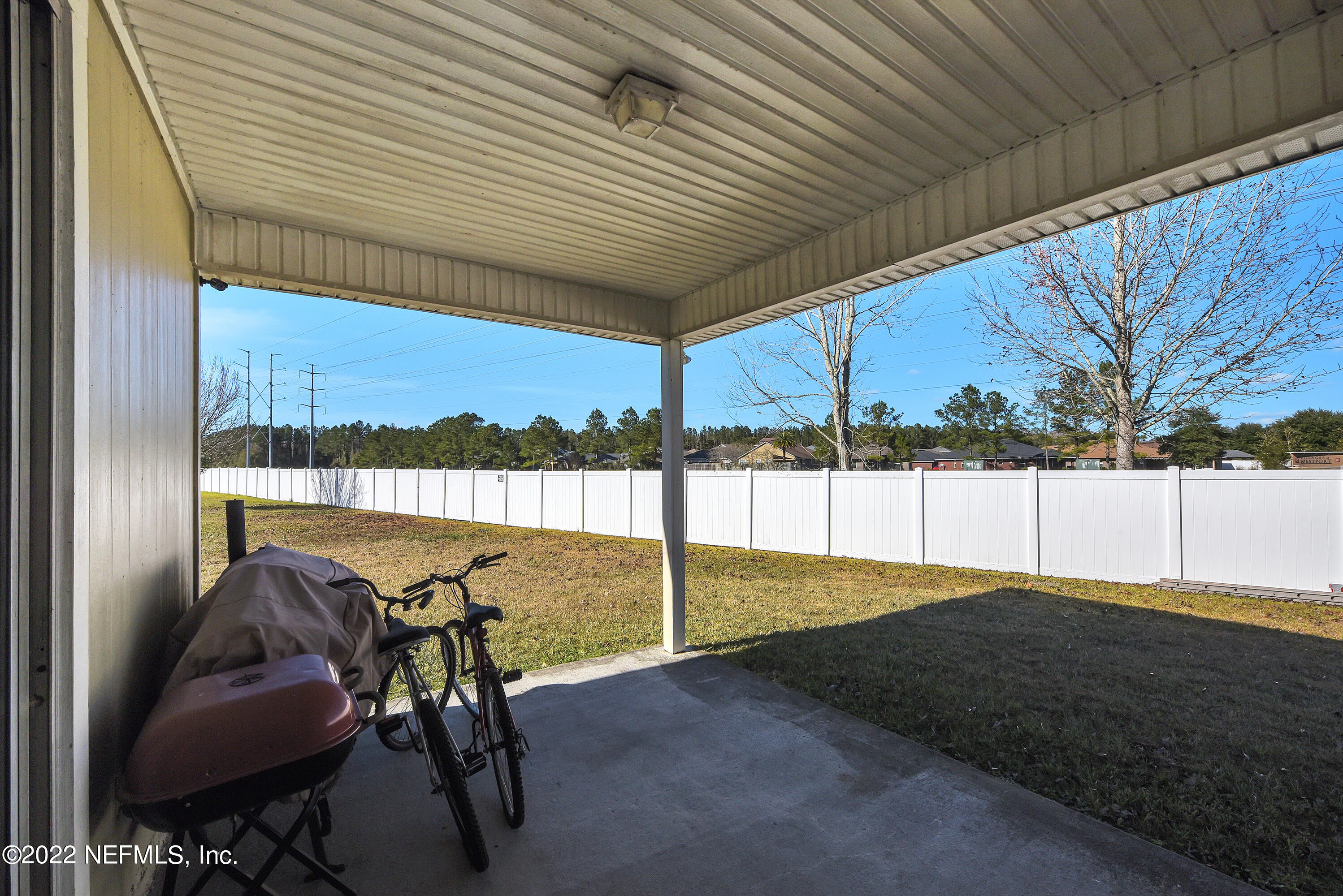 11941 Crooked River Road Jacksonville, FL 32219 - Photo 16 of 28 a view of a backyard with chair and a patio