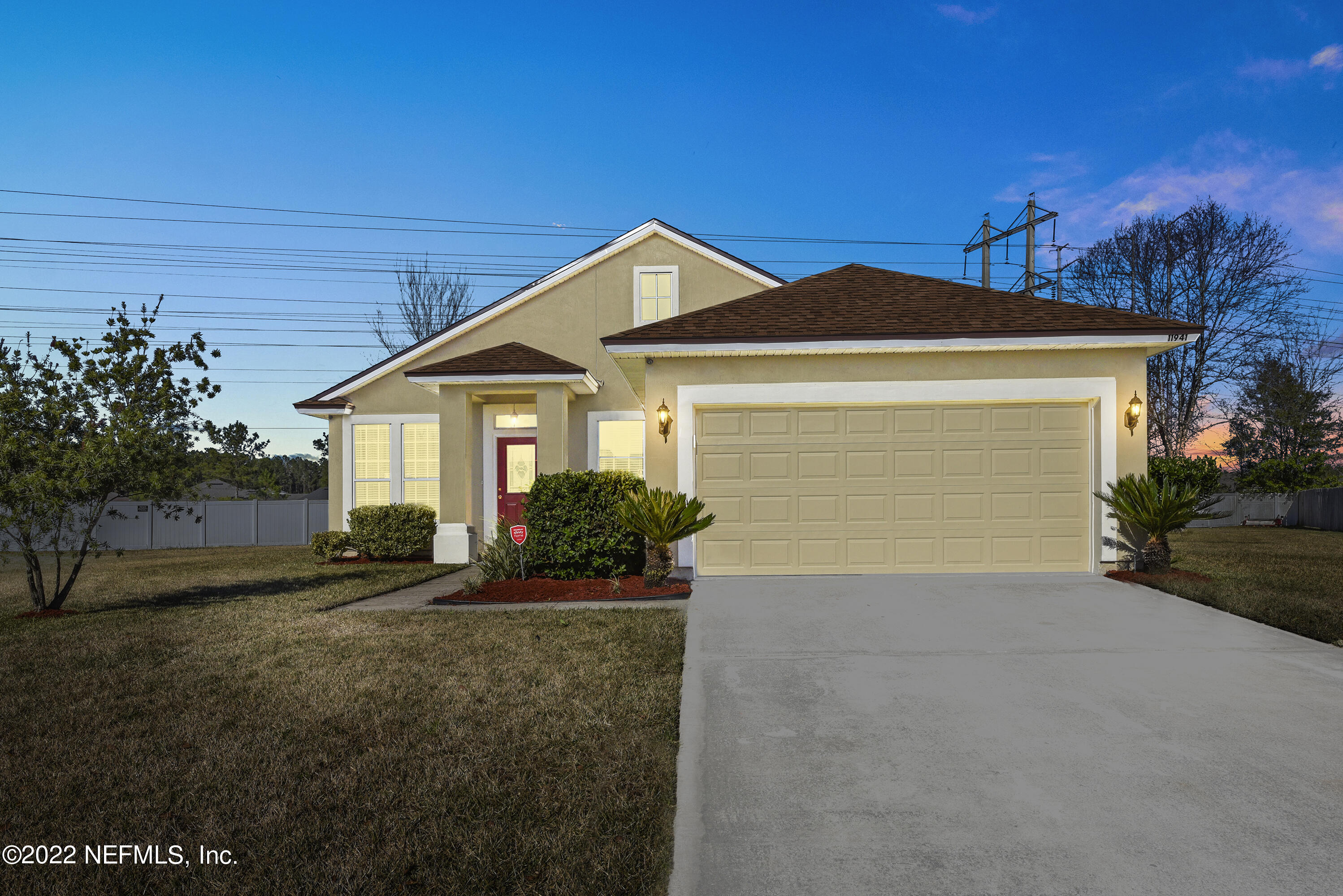 11941 Crooked River Road Jacksonville, FL 32219 - Photo 22 of 28 a front view of a house with a yard and garage