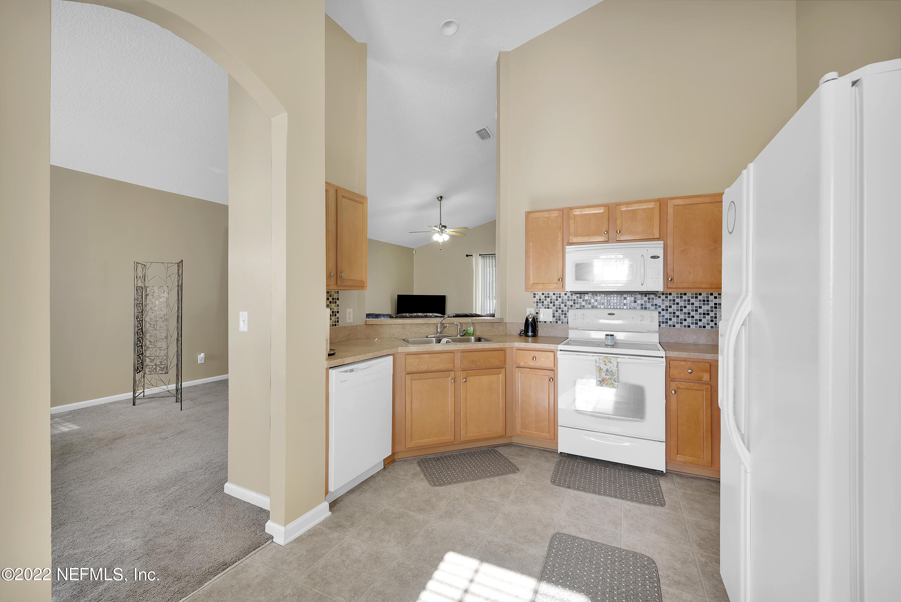 11941 Crooked River Road Jacksonville, FL 32219 - Photo 6 of 28 a kitchen with white cabinets and white appliances