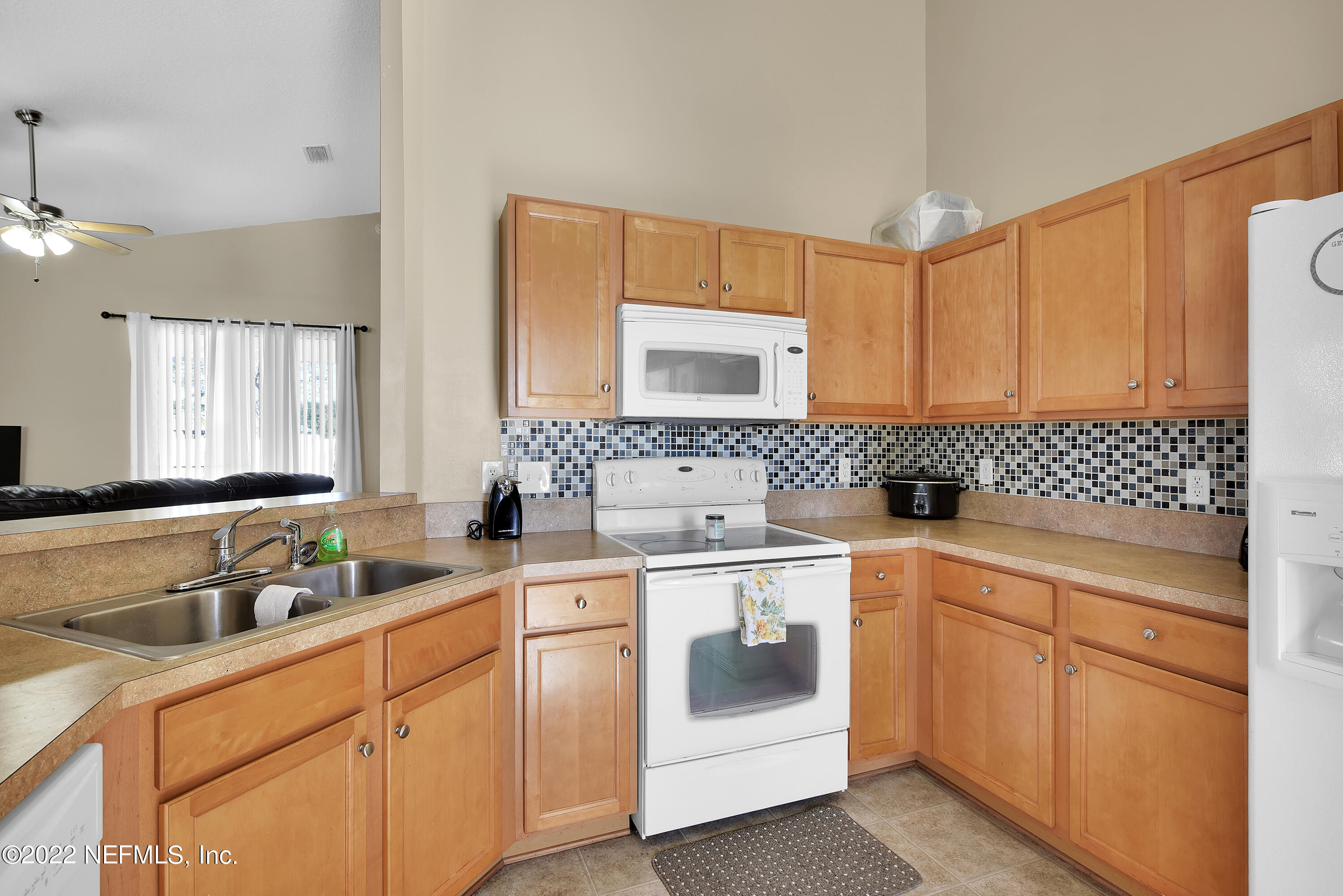 11941 Crooked River Road Jacksonville, FL 32219 - Photo 7 of 28 a kitchen with a sink stove and cabinets