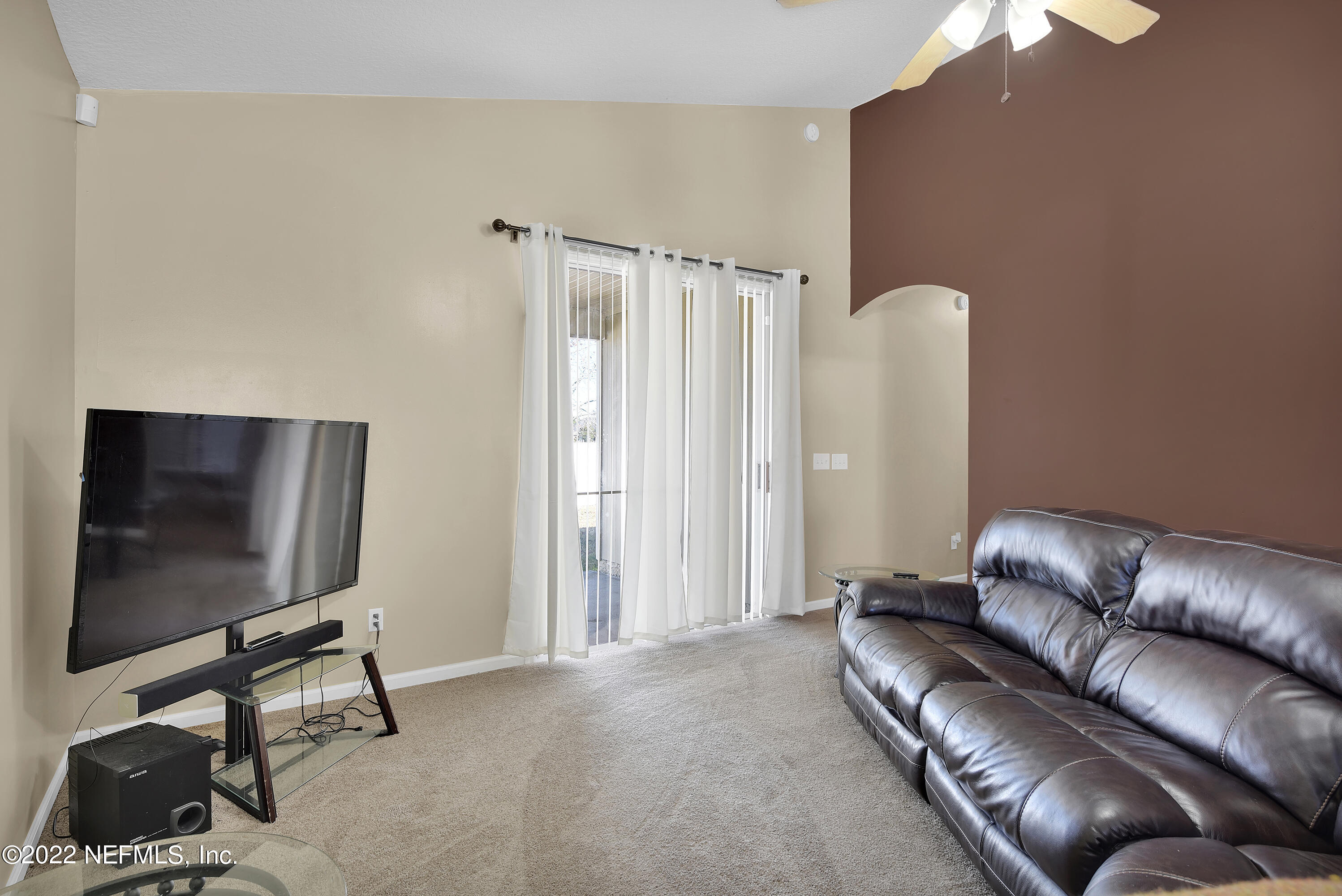 11941 Crooked River Road Jacksonville, FL 32219 - Photo 10 of 28 a living room with furniture and a flat screen tv