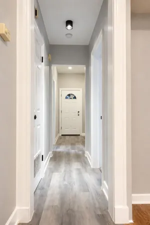 a view of a hallway with wooden shelves