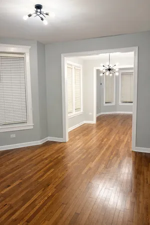a view of a room with wooden floor