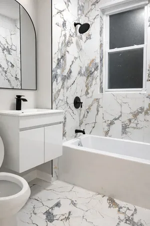 a bathroom with a sink toilet and shower