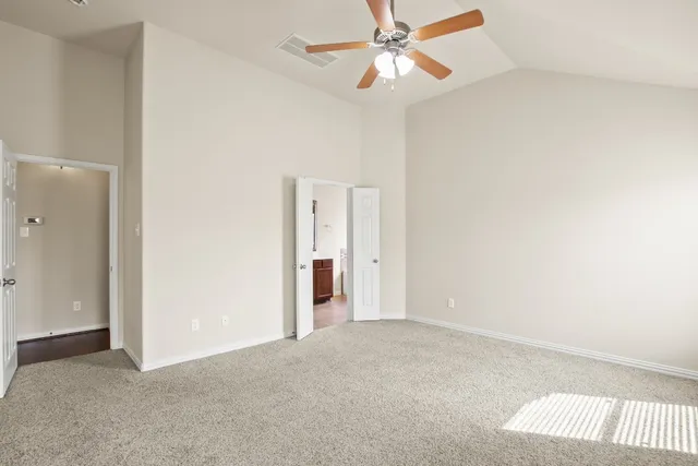 a view of an empty room with a fan