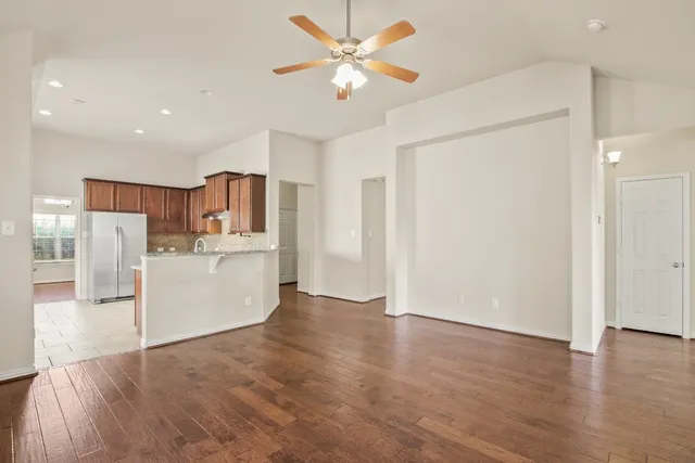 a view of a kitchen with a sink and a refrigerator