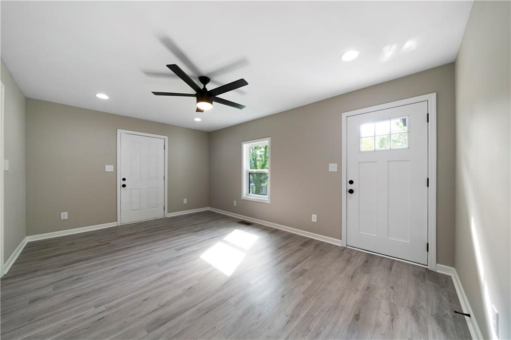 515 Harper Avenue Southwest Rome, GA 30161 - Photo 6 of 17 an empty room with wooden floor and windows