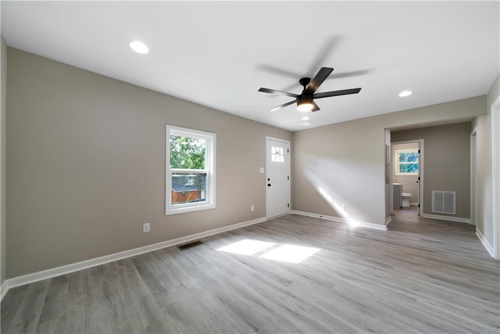 515 Harper Avenue Southwest Rome, GA 30161 - Photo 8 of 17 a view of empty room with wooden floor and fan