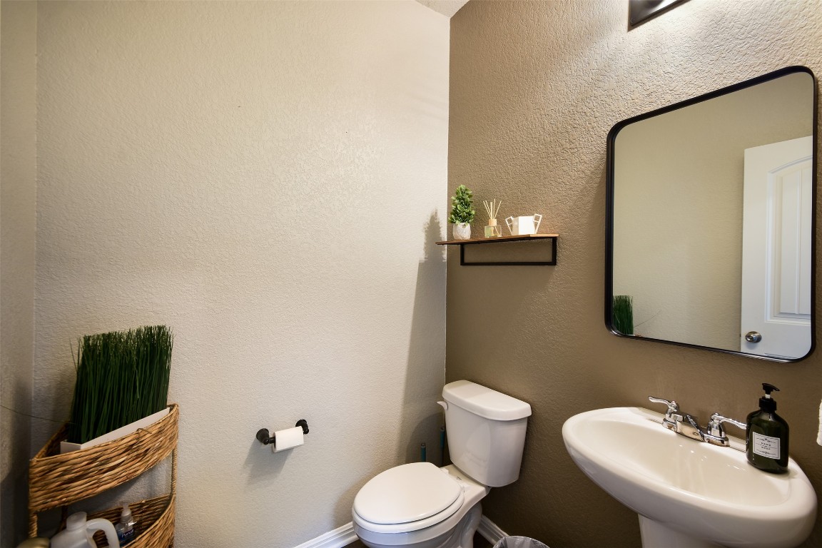 217 Frederick Drive Georgetown, TX 78626 - Photo 12 of 36 a bathroom with a toilet a sink and mirror