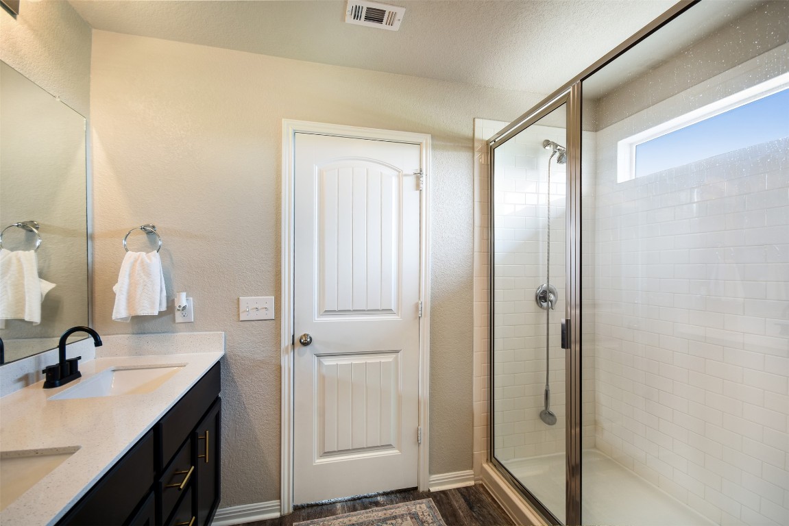 217 Frederick Drive Georgetown, TX 78626 - Photo 16 of 36 a bathroom with a granite countertop sink mirror and double