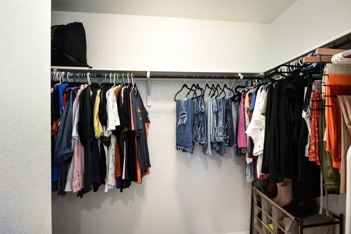 217 Frederick Drive Georgetown, TX 78626 - Photo 17 of 36 a view of walk in closet with clothes and shoes