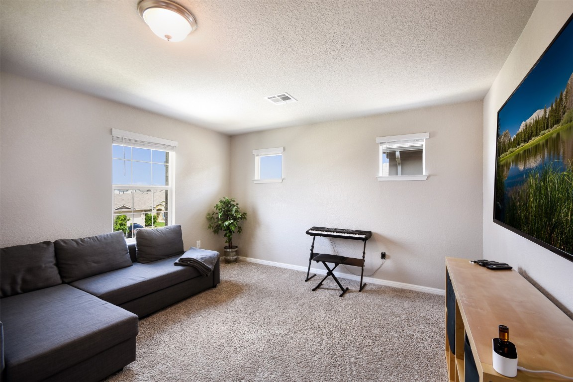 217 Frederick Drive Georgetown, TX 78626 - Photo 23 of 36 a living room with furniture and a flat screen tv
