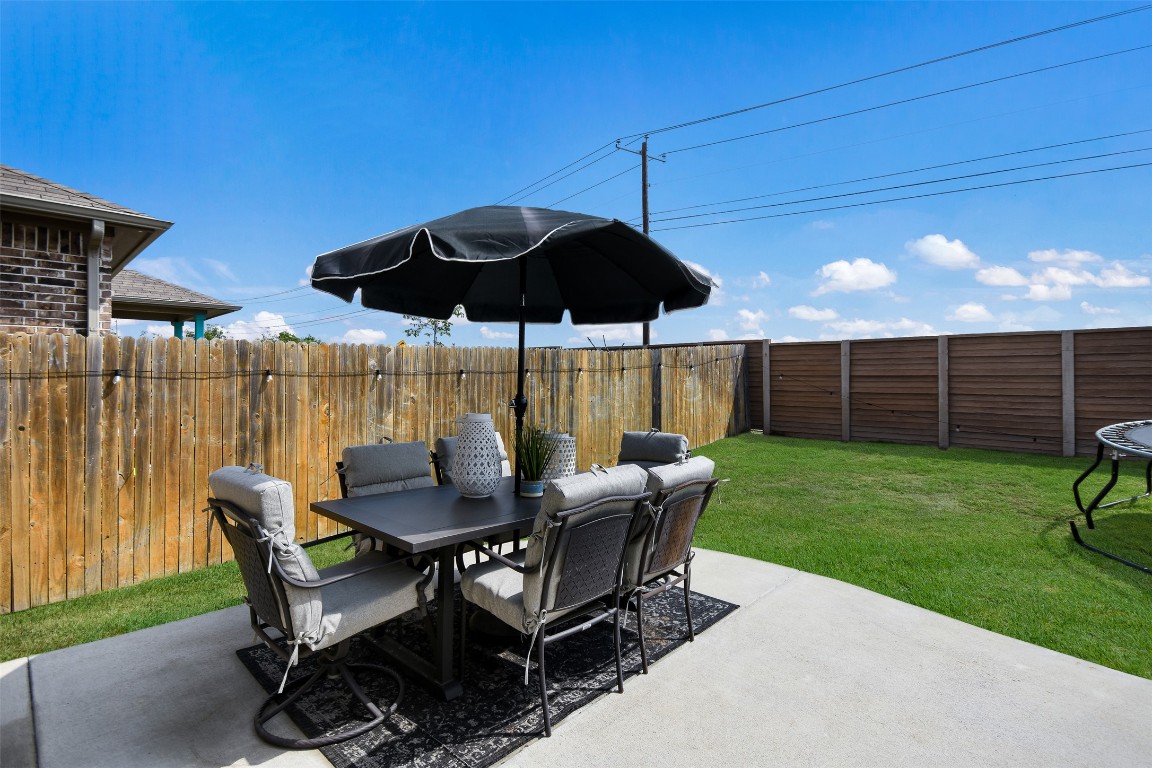 217 Frederick Drive Georgetown, TX 78626 - Photo 27 of 36 a view of a patio with a table chairs and a barbeque