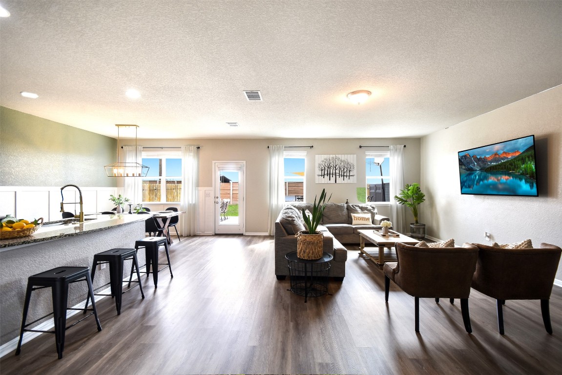 217 Frederick Drive Georgetown, TX 78626 - Photo 4 of 36 a living room with furniture kitchen view and a wooden floor