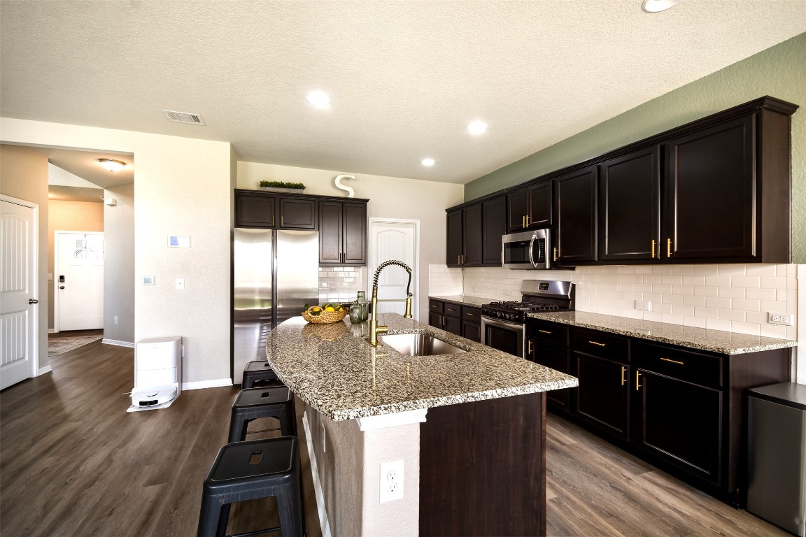 217 Frederick Drive Georgetown, TX 78626 - Photo 8 of 36 a kitchen with a sink and a refrigerator