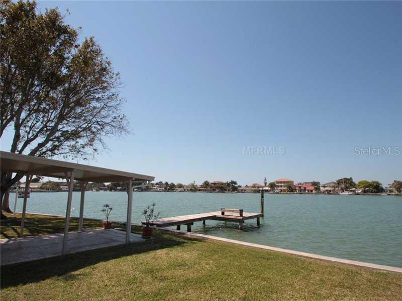 16137 4th Street East Redington Beach, FL 33708 - Photo 1 of 1 a view of a lake with lawn chairs