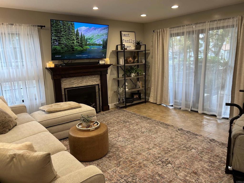 3546 Voyager Circle Carmel Valley, CA 92130 - Photo 11 of 28 a living room with furniture a fireplace and a flat screen tv