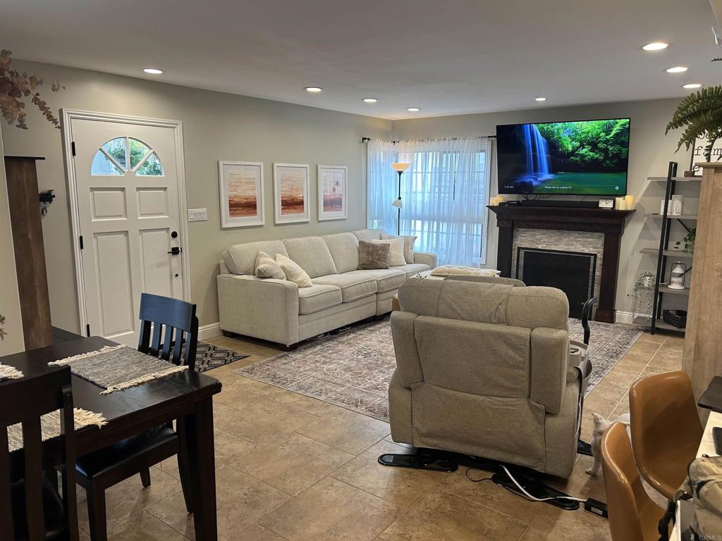 3546 Voyager Circle Carmel Valley, CA 92130 - Photo 12 of 28 a living room with furniture a flat screen tv and a fireplace