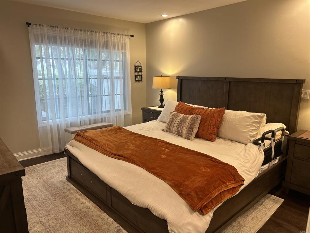 3546 Voyager Circle Carmel Valley, CA 92130 - Photo 15 of 28 a bedroom with a bed and wooden floor