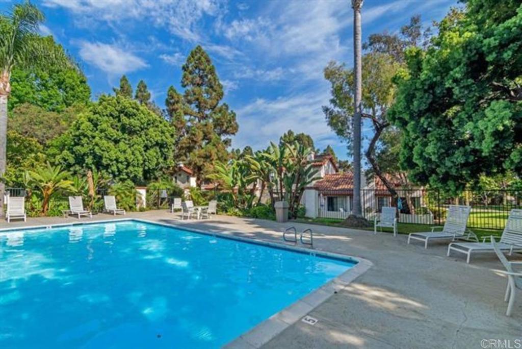 3546 Voyager Circle Carmel Valley, CA 92130 - Photo 22 of 28 a view of a swimming pool with lawn chairs under an umbrella