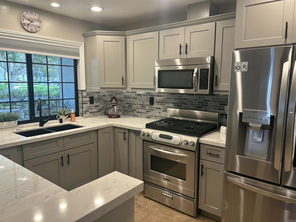 3546 Voyager Circle Carmel Valley, CA 92130 - Photo 6 of 28 a kitchen with stainless steel appliances a refrigerator sink and microwave