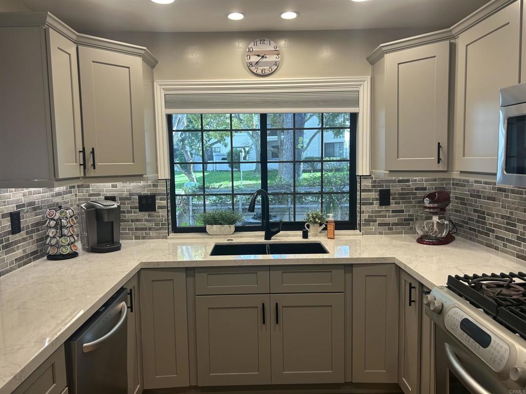 3546 Voyager Circle Carmel Valley, CA 92130 - Photo 7 of 28 a kitchen with a sink a stove and cabinets