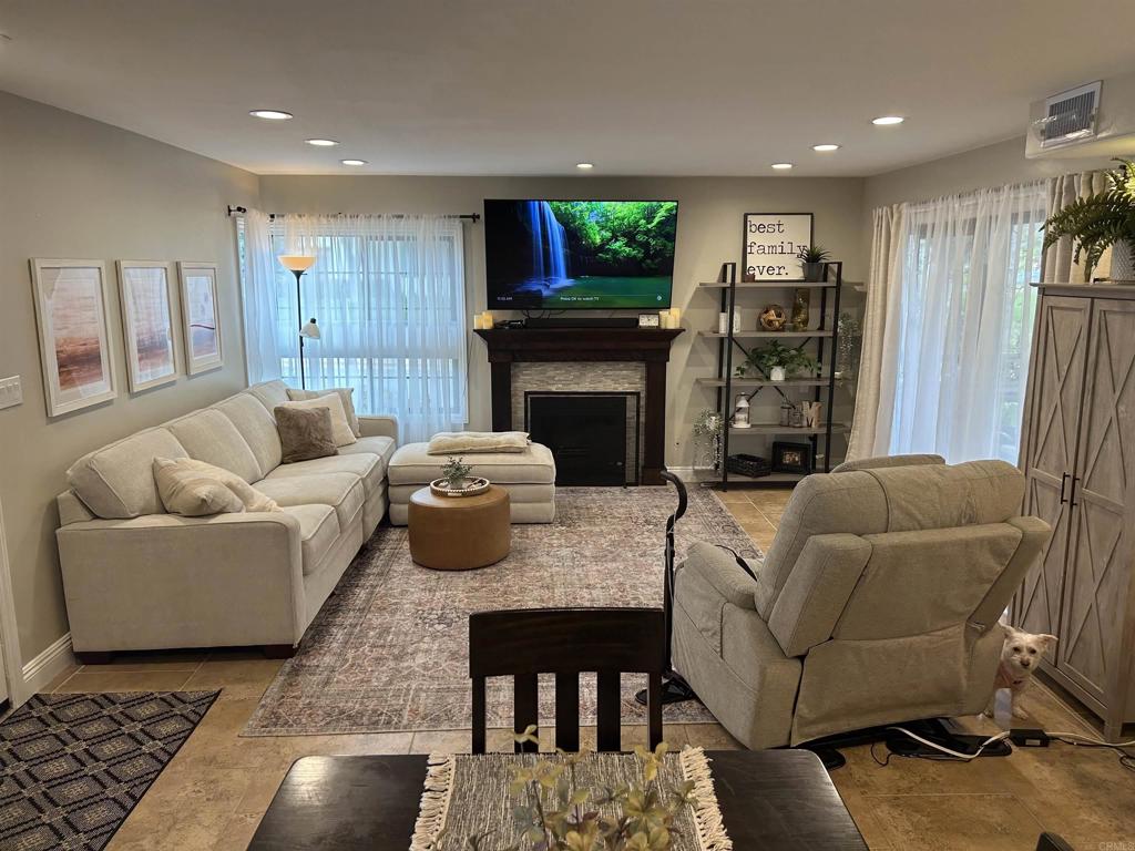 3546 Voyager Circle Carmel Valley, CA 92130 - Photo 8 of 28 a living room with furniture a flat screen tv and a fireplace