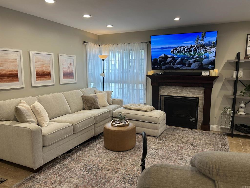 3546 Voyager Circle Carmel Valley, CA 92130 - Photo 10 of 28 a living room with furniture a flat screen tv and a fireplace