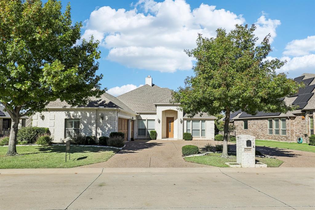 View of front of house featuring a garage and a front lawn