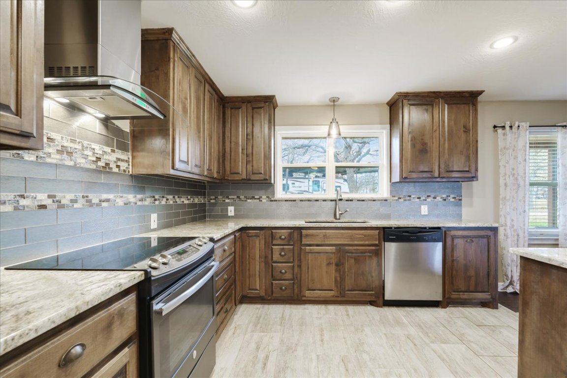 119 Lasso Loop Burnet, TX 78611 - Photo 12 of 35 a kitchen with stainless steel appliances granite countertop a sink stove and cabinets