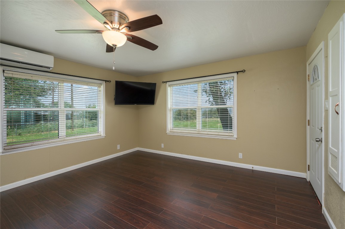 119 Lasso Loop Burnet, TX 78611 - Photo 14 of 35 a view of an empty room with wooden floor and a window