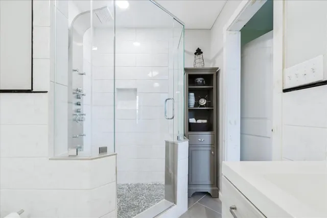 a bathroom with a bathtub and a shower