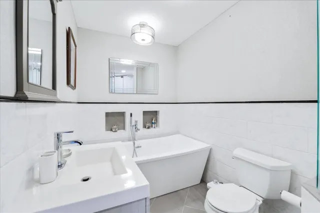 a bathroom with a sink mirror and toilet