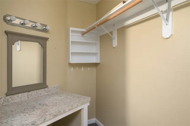 a bathroom with a granite countertop sink a mirror and vanity
