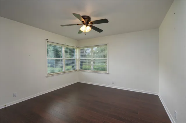 a view of wooden floor and windows in a room