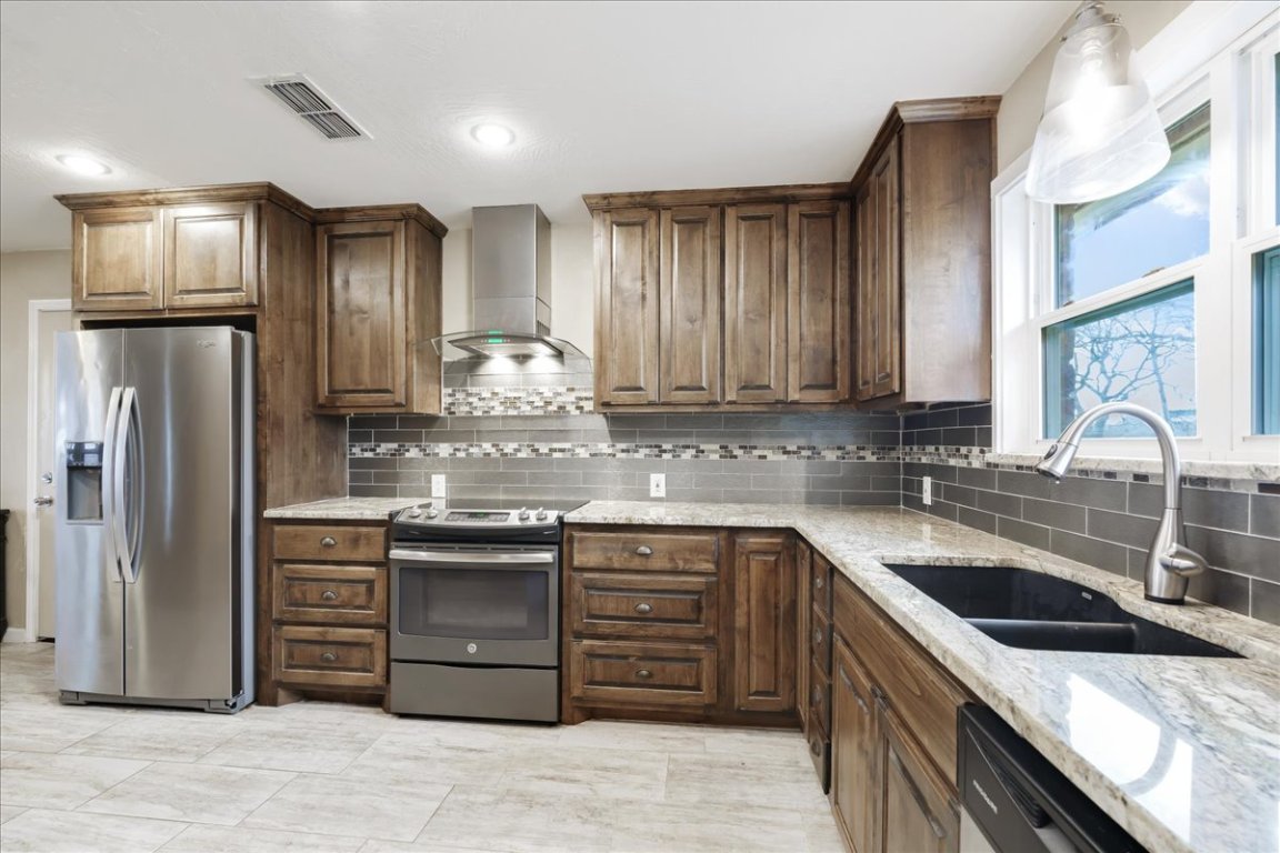 119 Lasso Loop Burnet, TX 78611 - Photo 3 of 35 a kitchen with stainless steel appliances granite countertop a sink stove and refrigerator