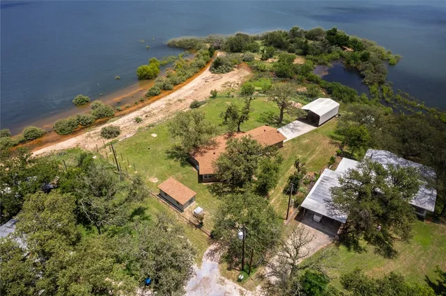 an aerial view of house with a yard