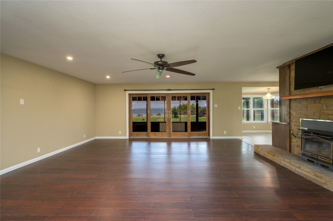 119 Lasso Loop Burnet, TX 78611 - Photo 9 of 35 a view of an empty room with wooden floor and a fireplace