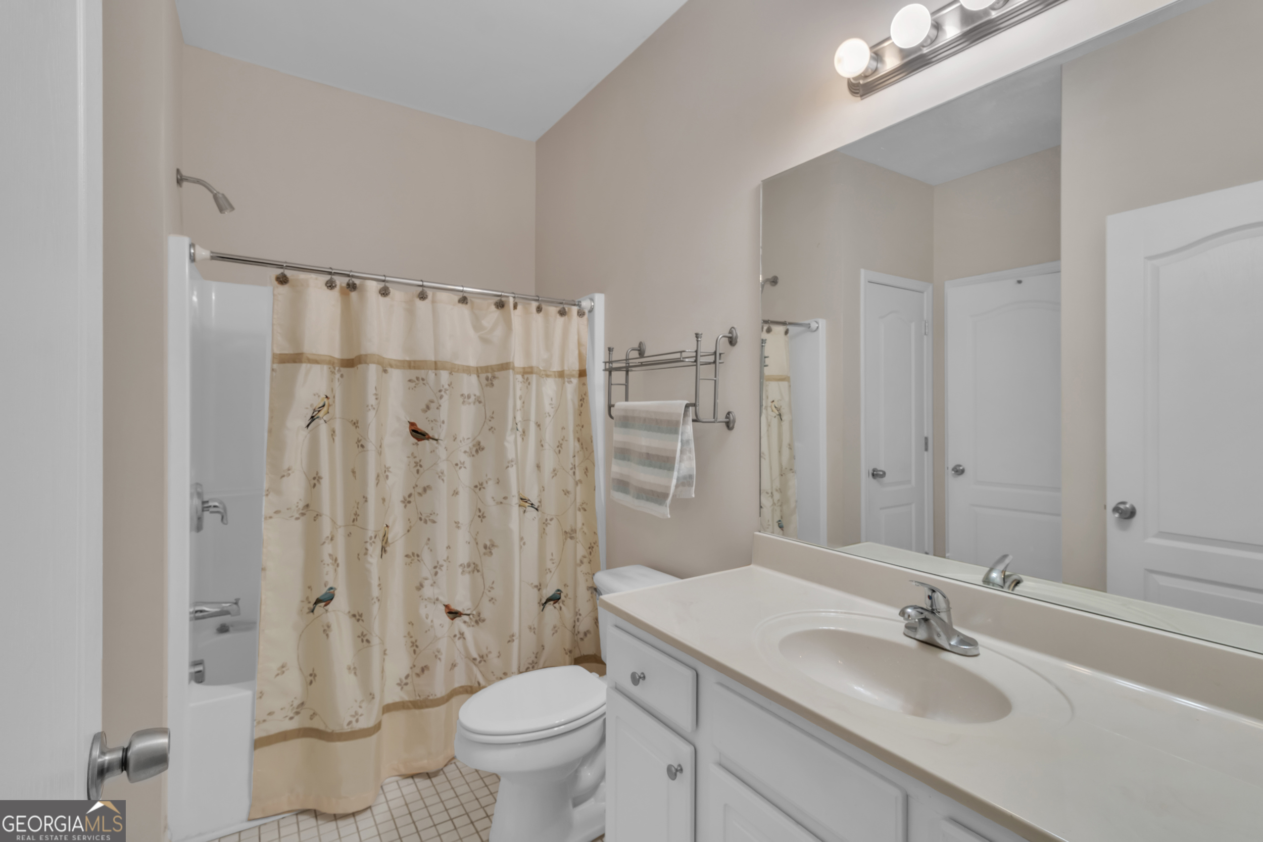 4557 Caleb Crossing, Unit 71 Powder Springs, GA 30127 - Photo 13 of 29 a bathroom with a sink toilet a mirror and shower
