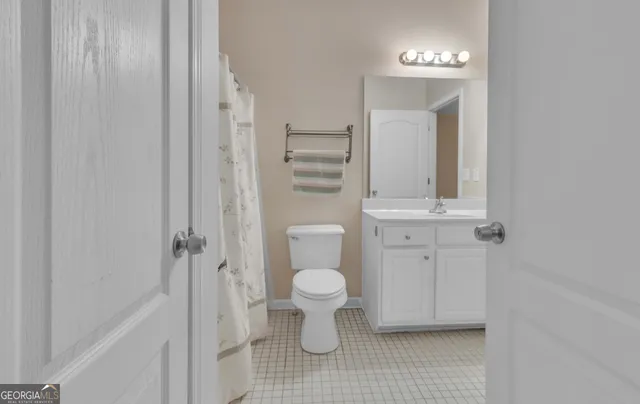 a bathroom with a toilet sink and a mirror