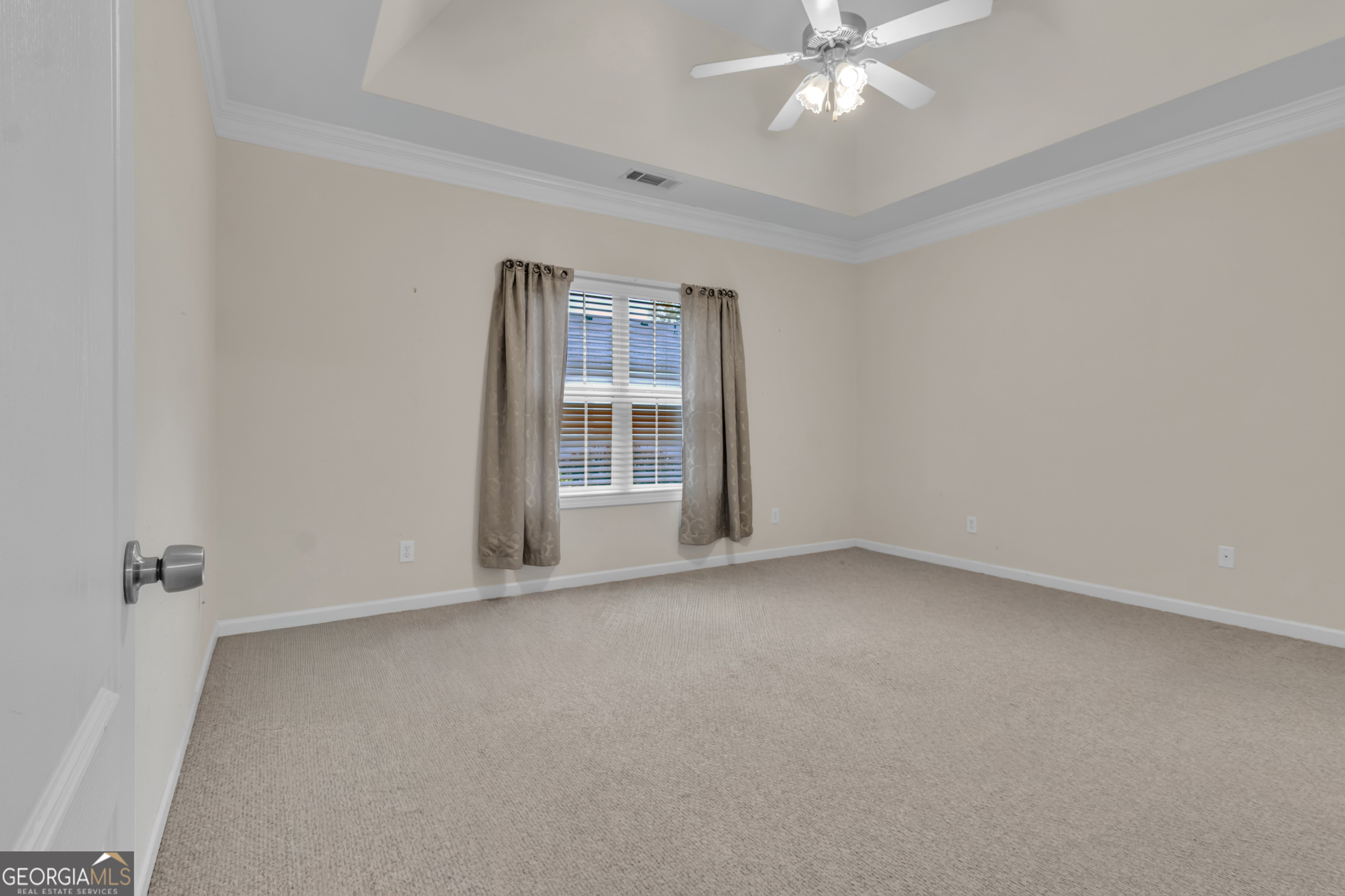 4557 Caleb Crossing, Unit 71 Powder Springs, GA 30127 - Photo 15 of 29 an empty room with chandelier fan and windows