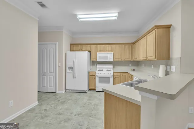 a kitchen with a sink a stove a refrigerator and cabinets