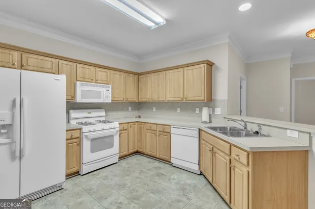 a kitchen with a sink stove and refrigerator