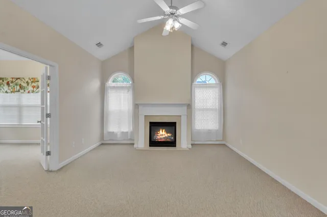a view of a livingroom with a fireplace and fan