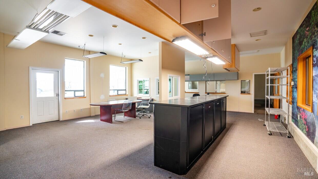 4770 Occidental Road Santa Rosa, CA 95401 - Photo 15 of 30 a large living room with stainless steel appliances furniture a fireplace and a large window
