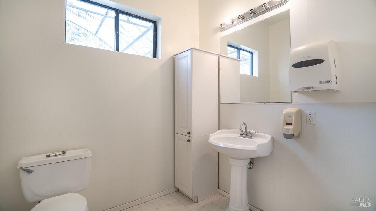 4770 Occidental Road Santa Rosa, CA 95401 - Photo 20 of 30 a bathroom with a sink a mirror and a toilet