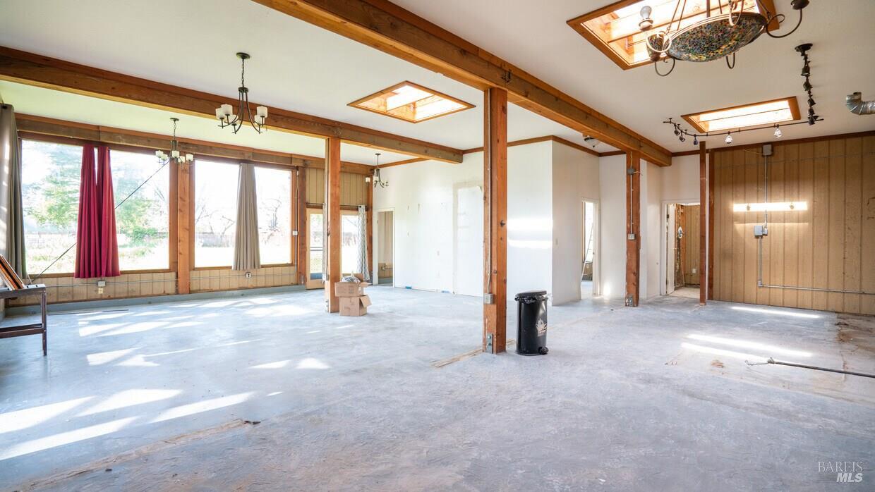 4770 Occidental Road Santa Rosa, CA 95401 - Photo 24 of 30 a view of an empty room with a fireplace and windows